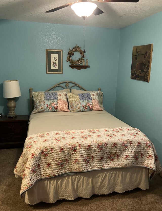 1810 Meadows Dr, Neosho, MO 64850 - bedroom featuring carpet floors, a textured ceiling, and ceiling fan