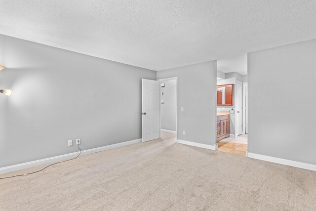4824 S Gold Rd, Battlefield, MO 65619 - empty room with light carpet, a textured ceiling, and baseboards