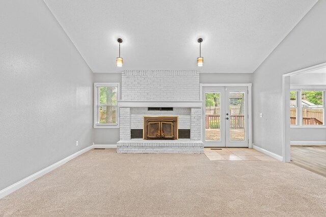4824 S Gold Rd, Battlefield, MO 65619 - unfurnished living room featuring vaulted ceiling, carpet flooring, plenty of natural light, and a brick fireplace
