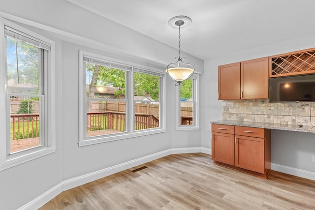 4824 S Gold Rd, Battlefield, MO 65619 - unfurnished dining area with light wood-style flooring and baseboards