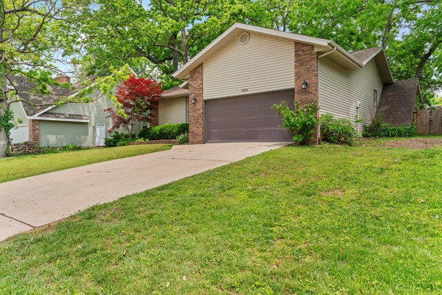4824 S Gold Rd, Battlefield, MO 65619 - view of front of property with concrete driveway, a front lawn, brick siding, and a garage