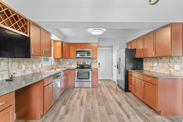 4824 S Gold Rd, Battlefield, MO 65619 - kitchen featuring appliances with stainless steel finishes, a sink, tasteful backsplash, and light stone countertops