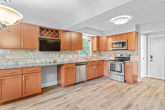 4824 S Gold Rd, Battlefield, MO 65619 - kitchen with appliances with stainless steel finishes, a sink, light wood finished floors, and tasteful backsplash