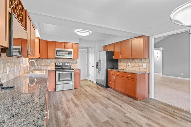4824 S Gold Rd, Battlefield, MO 65619 - kitchen featuring stainless steel appliances, baseboards, a sink, backsplash, and light wood-style flooring