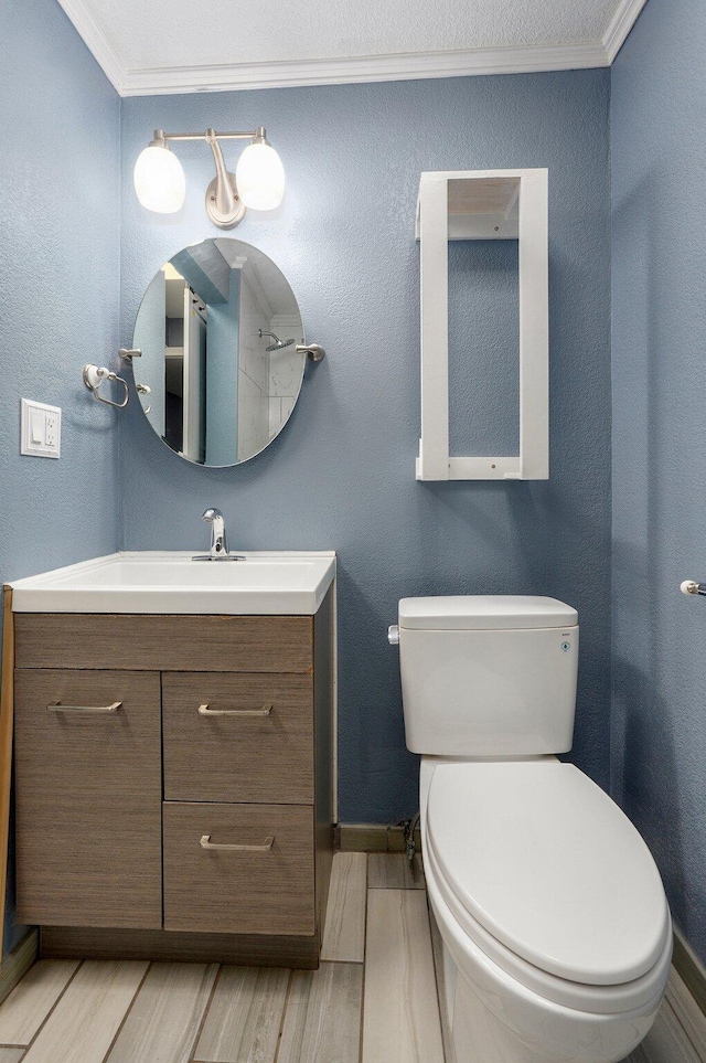 2418 E Catalpa St, Springfield, MO 65804 - bathroom featuring ornamental molding, baseboards, wood finished floors, toilet, and vanity