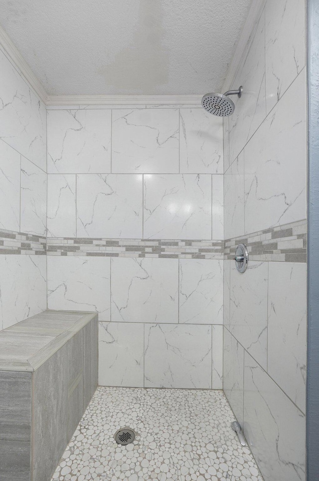 2418 E Catalpa St, Springfield, MO 65804 - bathroom with a tile shower, crown molding, and a textured ceiling