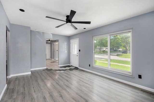 2418 E Catalpa St, Springfield, MO 65804 - unfurnished living room with wood finished floors, baseboards, and ceiling fan