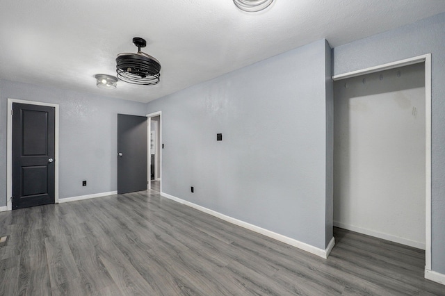 2418 E Catalpa St, Springfield, MO 65804 - unfurnished bedroom with wood finished floors and baseboards