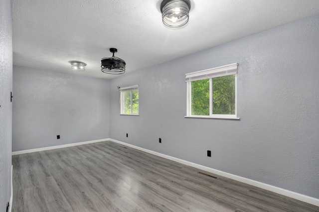 2418 E Catalpa St, Springfield, MO 65804 - empty room with baseboards and wood finished floors