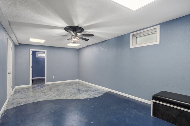 2418 E Catalpa St, Springfield, MO 65804 - unfurnished room featuring unfinished concrete flooring, ceiling fan, baseboards, and a textured ceiling