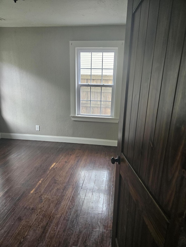 1629 W Webster St, Springfield, MO 65802 - spare room with dark wood-type flooring and baseboards