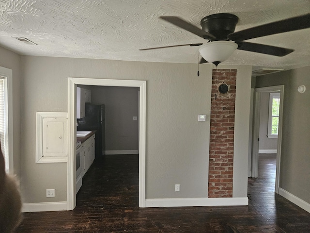 1629 W Webster St, Springfield, MO 65802 - empty room featuring baseboards, wood finished floors, ceiling fan, and a textured ceiling