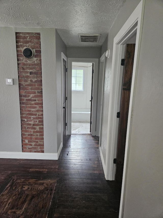 1629 W Webster St, Springfield, MO 65802 - corridor featuring hardwood / wood-style floors, a textured ceiling, and baseboards