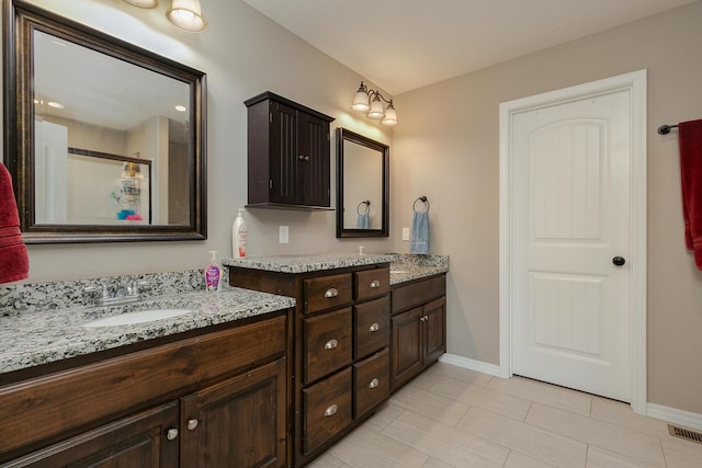 1918 N Brook Hollow Dr, Nixa, MO 65714 - full bath with baseboards, double vanity, and a shower with shower door