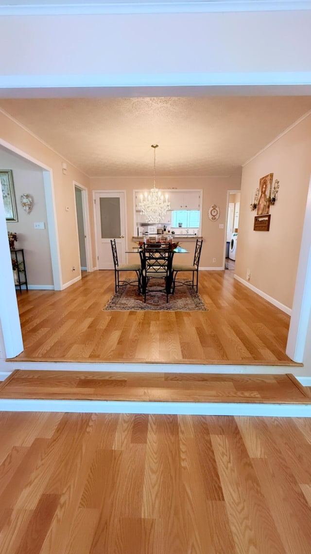 1909 S Nettleton Ave, Springfield, MO 65807 - dining space featuring a chandelier, light wood-type flooring, and baseboards