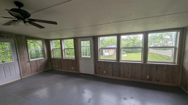 1301 W Main St, West Plains, MO 65775 - unfurnished sunroom with plenty of natural light, wooden walls, vaulted ceiling, and baseboards