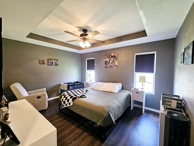 1620 Jon St, West Plains, MO 65775 - bedroom featuring a tray ceiling, dark wood-style floors, and baseboards