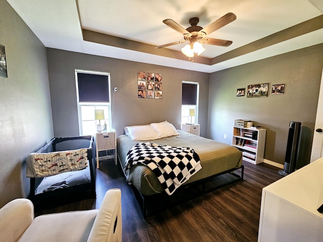 1620 Jon St, West Plains, MO 65775 - bedroom featuring dark wood-type flooring, baseboards, a tray ceiling, and ceiling fan