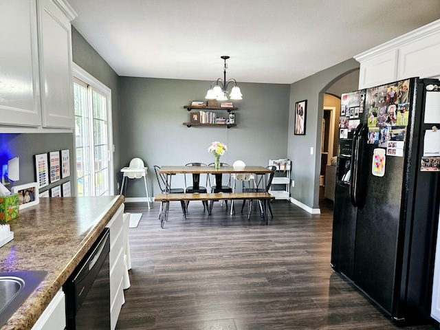 1620 Jon St, West Plains, MO 65775 - dining space featuring arched walkways, dark wood-style floors, a chandelier, and baseboards