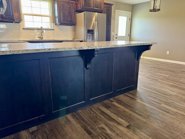 4692 S 125th Rd, Bolivar, MO 65613 - kitchen with stainless steel fridge with ice dispenser, a sink, a kitchen breakfast bar, and dark wood-type flooring