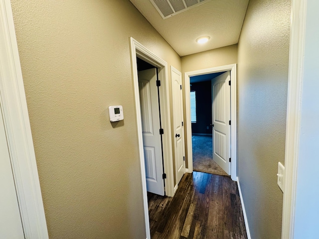 4692 S 125th Rd, Bolivar, MO 65613 - hall with dark wood finished floors, a textured wall, and baseboards
