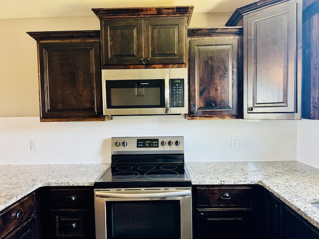 4692 S 125th Rd, Bolivar, MO 65613 - kitchen with stainless steel appliances, backsplash, dark brown cabinets, and light stone counters