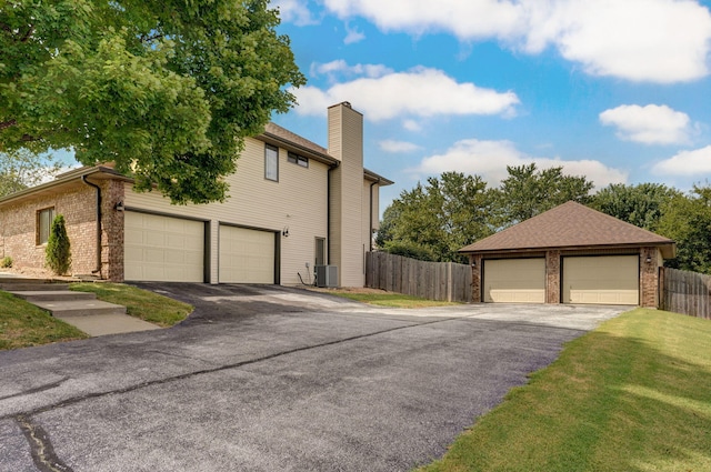 2019 N Preakness Dr, Nixa, MO 65714 - view of property exterior with a chimney, brick siding, and central AC unit
