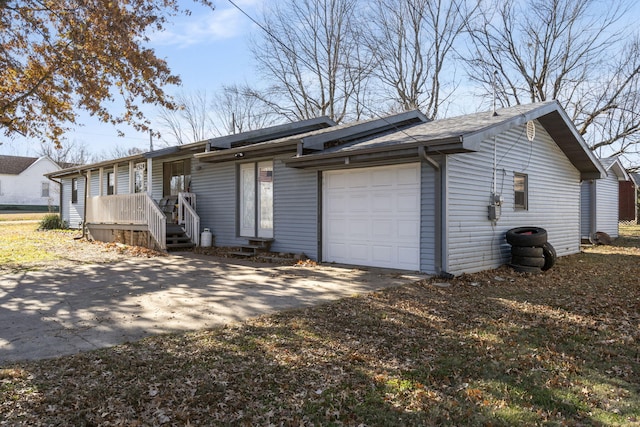 1529 S Jefferson Ave, Aurora, MO 65605 - view of property exterior featuring an attached garage and concrete driveway