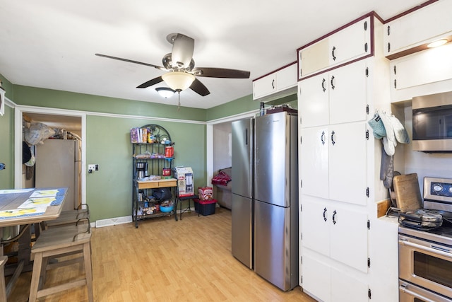 1529 S Jefferson Ave, Aurora, MO 65605 - kitchen with appliances with stainless steel finishes, ceiling fan, white cabinetry, light wood-type flooring, and baseboards