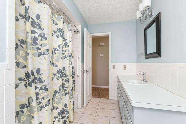 3729 S Parklane Ave, Springfield, MO 65807 - full bath with vanity, tile patterned flooring, tile walls, a shower with shower curtain, and a textured ceiling