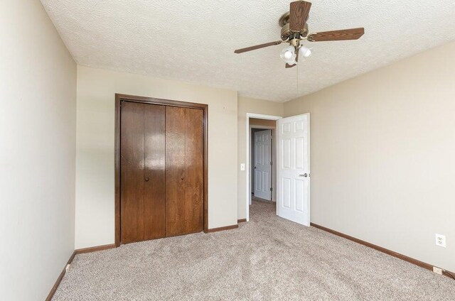 3729 S Parklane Ave, Springfield, MO 65807 - unfurnished bedroom featuring light colored carpet, a closet, baseboards, a textured ceiling, and a ceiling fan