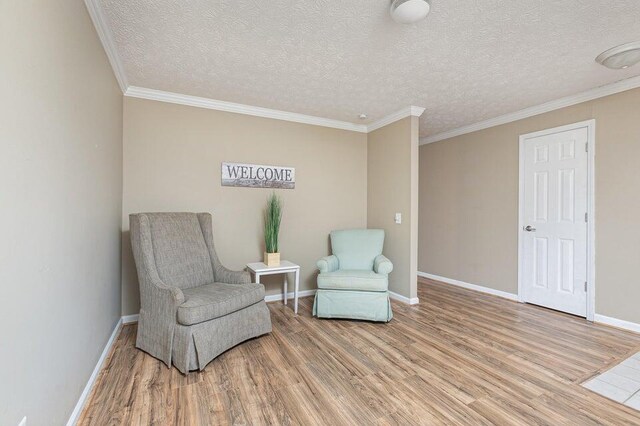 3729 S Parklane Ave, Springfield, MO 65807 - sitting room with light wood-type flooring, baseboards, ornamental molding, and a textured ceiling