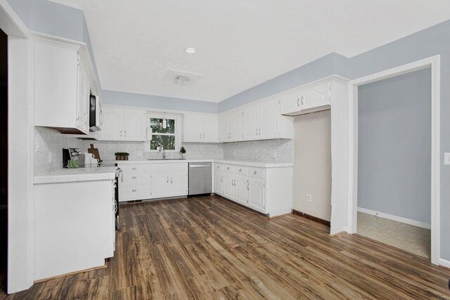 3729 S Parklane Ave, Springfield, MO 65807 - kitchen featuring stainless steel dishwasher, dark wood-type flooring, white cabinets, decorative backsplash, and a sink