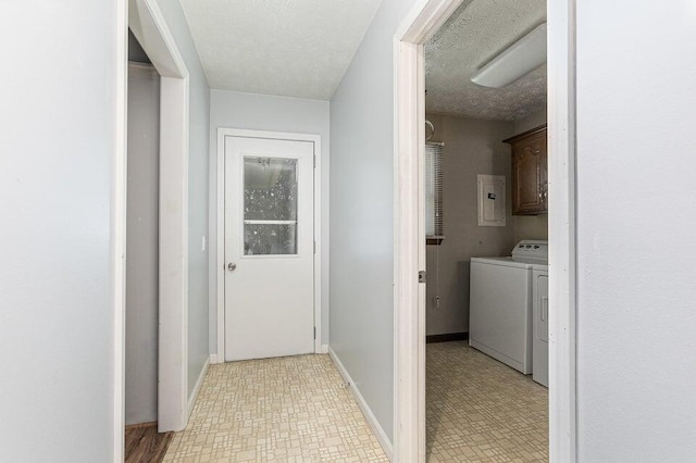 3729 S Parklane Ave, Springfield, MO 65807 - hallway featuring washer and dryer, electric panel, light floors, baseboards, and a textured ceiling