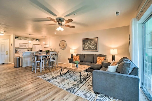 120 Spring Creek Ct Unit 12, Branson, MO 65616 - living area featuring ceiling fan, light wood-style floors, and baseboards
