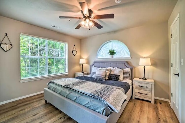 120 Spring Creek Ct Unit 12, Branson, MO 65616 - bedroom with multiple windows, wood finished floors, and baseboards
