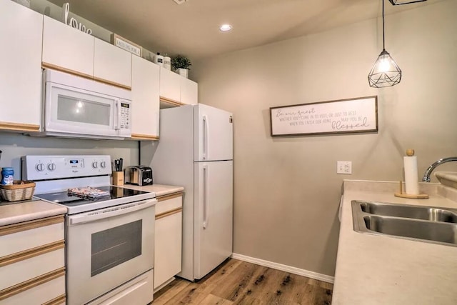 120 Spring Creek Ct Unit 12, Branson, MO 65616 - kitchen with white appliances, a sink, light countertops, light wood-style flooring, and recessed lighting