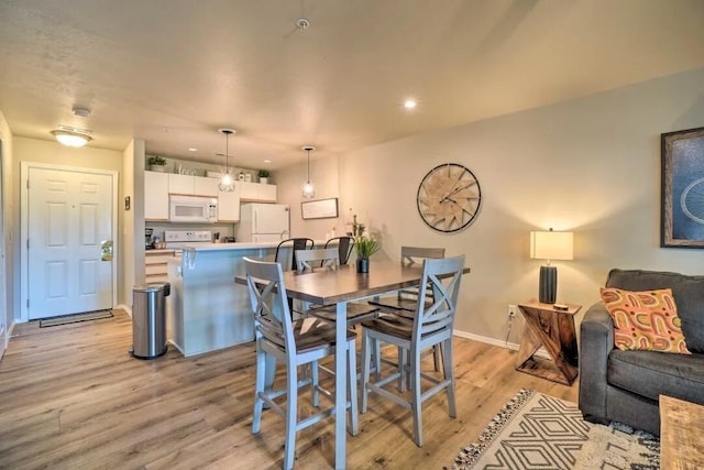 120 Spring Creek Ct Unit 12, Branson, MO 65616 - dining space with light wood-style flooring, baseboards, and recessed lighting