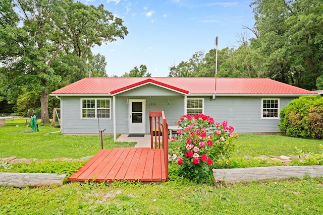 1356 State Highway 32, Long Lane, MO 65590 - view of front facade with metal roof, a front yard, and a wooden deck