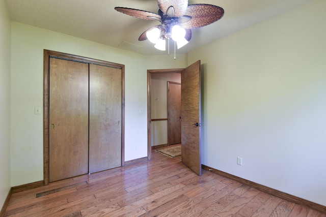 1605 Hideaway Rd, Galena, MO 65656 - unfurnished bedroom with baseboards, wood finished floors, a closet, and ceiling fan