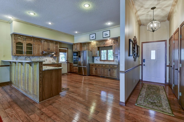 1605 Hideaway Rd, Galena, MO 65656 - kitchen with stainless steel appliances, crown molding, a peninsula, under cabinet range hood, and a textured ceiling