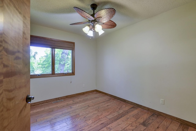 1605 Hideaway Rd, Galena, MO 65656 - unfurnished room featuring wood finished floors, ceiling fan, baseboards, and a textured ceiling