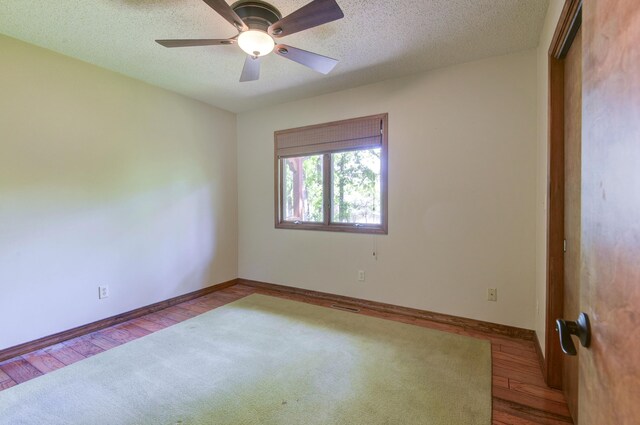 1605 Hideaway Rd, Galena, MO 65656 - empty room with a ceiling fan, baseboards, wood finished floors, and a textured ceiling