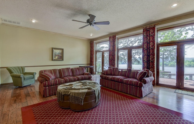 1605 Hideaway Rd, Galena, MO 65656 - living area with wood-type flooring, plenty of natural light, a ceiling fan, a textured ceiling, and ornamental molding