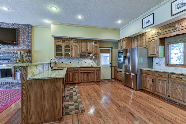 1605 Hideaway Rd, Galena, MO 65656 - kitchen with a sink, ornamental molding, appliances with stainless steel finishes, a peninsula, and a textured ceiling