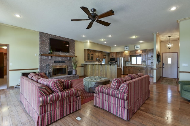 1605 Hideaway Rd, Galena, MO 65656 - living room featuring ceiling fan, hardwood / wood-style flooring, a fireplace, recessed lighting, and crown molding