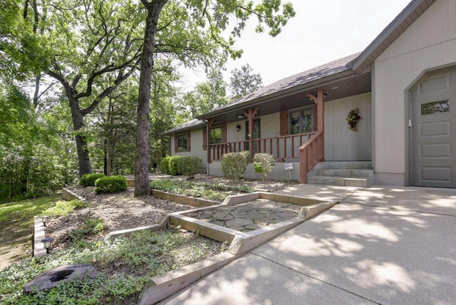 1605 Hideaway Rd, Galena, MO 65656 - view of front facade featuring covered porch, a garage, and roof with shingles