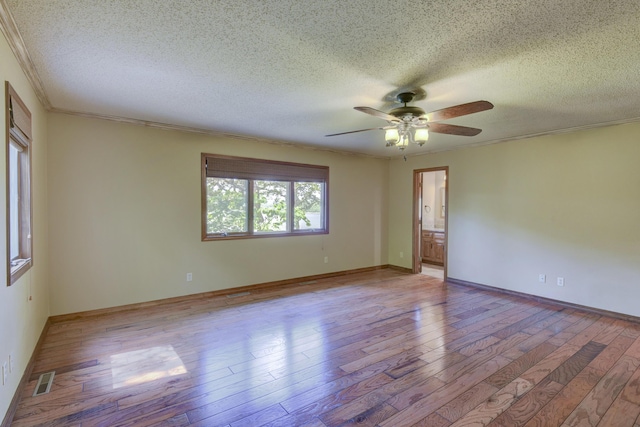1605 Hideaway Rd, Galena, MO 65656 - empty room with a textured ceiling, ceiling fan, light wood-type flooring, crown molding, and baseboards