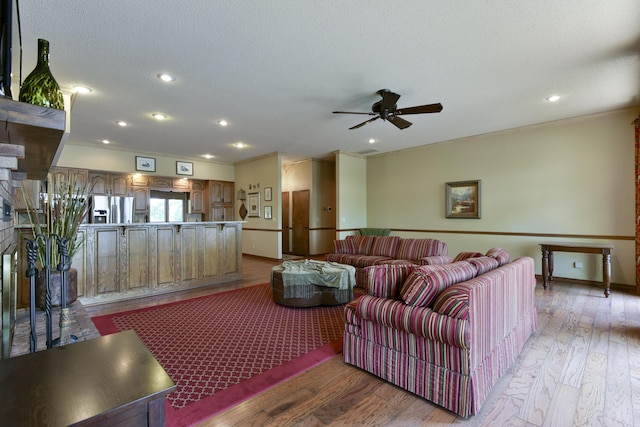 1605 Hideaway Rd, Galena, MO 65656 - living area with crown molding, a ceiling fan, light wood-type flooring, a glass covered fireplace, and baseboards