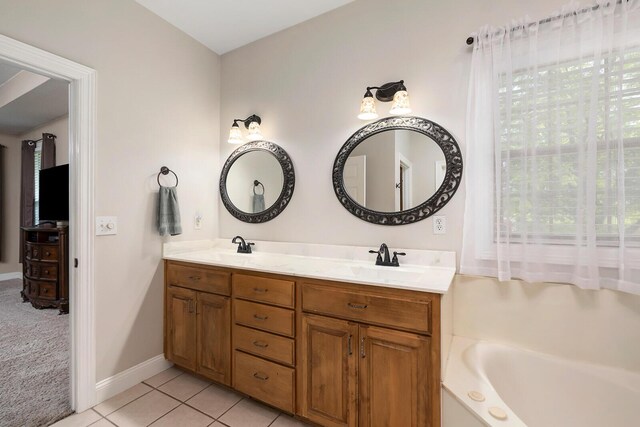 2310 Lakeside Ct, Ozark, MO 65721 - bathroom with tile patterned flooring, double vanity, a bathtub, and baseboards